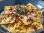 Olive Garden-inspired ravioli carbonara crunch served in a skillet with crispy breadcrumbs, creamy carbonara sauce, cheese-filled ravioli, and garnished with parsley.