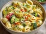 One pot veggie mac and cheese with creamy cheese sauce, tender pasta, and colorful vegetables like broccoli, carrots, and peas, served hot in a skillet.
