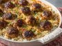 Honey garlic meatball rice bake served in a casserole dish, featuring tender meatballs, fluffy rice, sweet and savory honey garlic sauce, and melted cheese garnished with parsley.