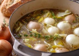 Homemade onion boil recipe with tender boiled onions, seasoned broth, and fresh herbs served in a rustic pot.