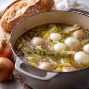 Homemade onion boil recipe with tender boiled onions, seasoned broth, and fresh herbs served in a rustic pot.