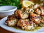 Chicken souvlaki skewers marinated in olive oil, lemon juice, garlic, and herbs, grilled to perfection and served with pita bread, tzatziki, and fresh vegetables.