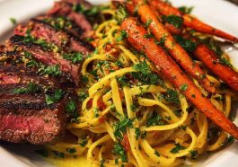 Cowboy butter steak linguine served in a rustic bowl with tender steak slices, creamy linguine tossed in cowboy butter sauce, roasted carrots, and fresh parsley garnish.