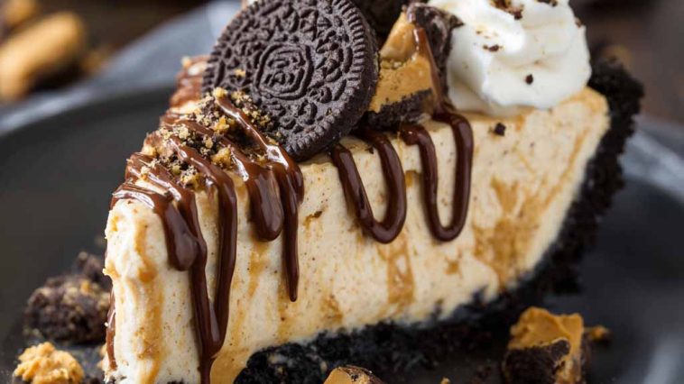 Unbelievable peanut butter pie with Oreo crust and creamy filling, topped with whipped cream and mini peanut butter cups, served chilled on a dessert plate.