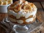 Cottage cheese banana pudding served in a glass dish with layers of creamy cottage cheese, sliced bananas, vanilla wafers, and whipped topping, garnished with fresh banana slices.