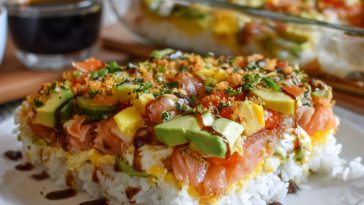 Easy sushi bake with layers of rice, crab, and creamy sauce baked golden in a casserole dish.