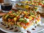 Easy sushi bake with layers of rice, crab, and creamy sauce baked golden in a casserole dish.