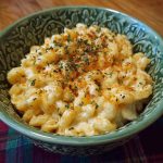 Simple Boursin mac and cheese served in a bowl with creamy sauce made from Boursin cheese, topped with fresh herbs and a golden breadcrumb crust.