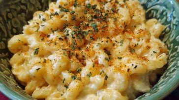 Simple Boursin mac and cheese served in a bowl with creamy sauce made from Boursin cheese, topped with fresh herbs and a golden breadcrumb crust.