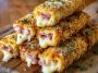 Golden baked ham and cheese sticks with melted cheese and savory ham wrapped in flaky pastry, served warm with dipping sauce.