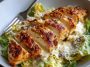 Creamy Parmesan baked Caesar chicken served in a casserole dish, garnished with fresh parsley.