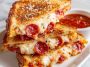 Pizza grilled cheese sandwich with golden toasted bread, melted mozzarella, pepperoni slices, and marinara sauce, served hot with a dipping cup of tomato sauce.