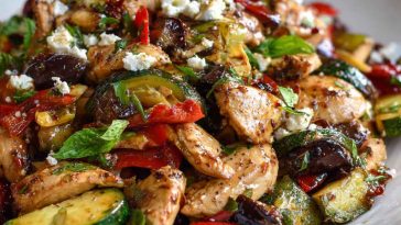 Mediterranean chicken stir-fry cooked with colorful bell peppers, zucchini, onions, and cherry tomatoes, tossed in olive oil and herbs, served in a skillet as a healthy 30-minute dinner.