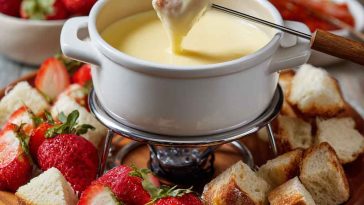 Assorted fondue recipes featuring melted cheese, chocolate, and broth fondues served with bread cubes, fruits, and vegetables on a festive table.