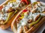 Ultimate chicken Philly cheese steaks served in toasted hoagie rolls, filled with juicy chicken, sautéed peppers, onions, and melted provolone cheese.