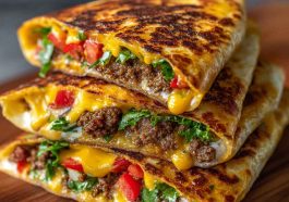 Keto crunchwraps recipe made with low-carb tortillas, seasoned ground beef, cheese, lettuce, tomato, and sour cream, folded and grilled golden brown for a crispy finish.