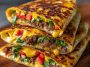 Keto crunchwraps recipe made with low-carb tortillas, seasoned ground beef, cheese, lettuce, tomato, and sour cream, folded and grilled golden brown for a crispy finish.
