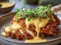 Crispy pretzel chicken served with creamy mustard-cheddar sauce, golden brown breaded chicken cutlets topped with rich cheese sauce, garnished with parsley and served on a rustic plate.