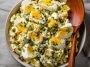Lemon caper egg salad served in a bowl with chopped hard-boiled eggs, creamy dressing, tangy capers, and fresh herbs, garnished with lemon zest and parsley.
