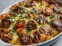 Golden pancake sausage casserole baked in a dish with fluffy layers of pancake, savory sausage, and melted cheese.