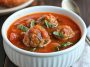 Hearty meatball tomato soup with tender beef meatballs, rich tomato broth, and fresh herbs served in a rustic bowl.