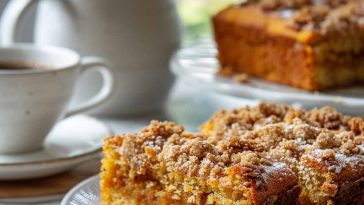 Freshly baked pumpkin spiced coffee cake with crumb topping on a plate