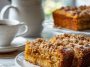 Freshly baked pumpkin spiced coffee cake with crumb topping on a plate
