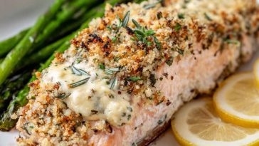 A golden-baked salmon fillet topped with creamy Boursin cheese and fresh herbs, served with roasted vegetables.