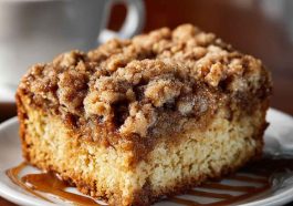 Moist crumb coffee cake topped with buttery cinnamon streusel and served with a cup of hot coffee.