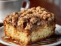 Moist crumb coffee cake topped with buttery cinnamon streusel and served with a cup of hot coffee.
