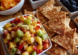 Fresh fruit salsa with strawberries, kiwi, and pineapple served with crispy cinnamon sugar tortilla chips on the side.