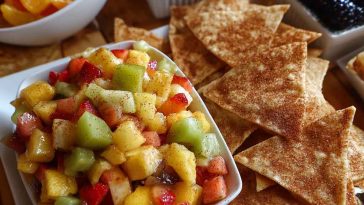 Fresh fruit salsa with strawberries, kiwi, and pineapple served with crispy cinnamon sugar tortilla chips on the side.
