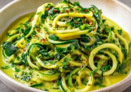 Creamy zucchini sauce made with fresh zucchini, garlic, olive oil, and herbs, served over pasta in a white bowl.