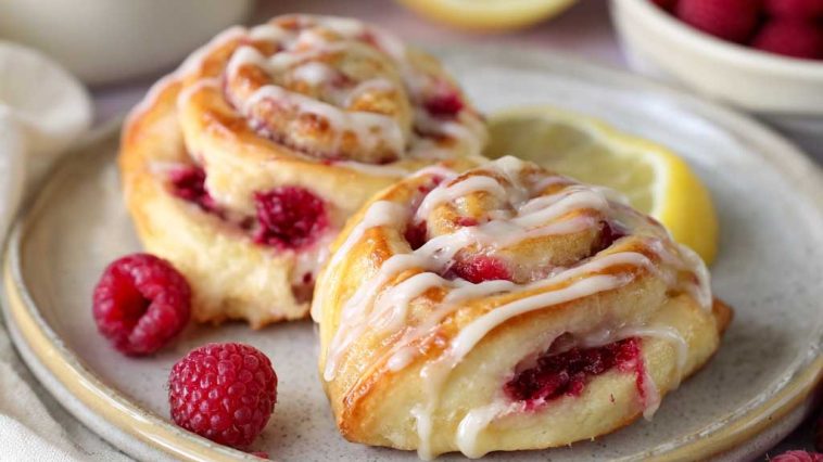 Freshly baked lemon raspberry cream cheese Danish rolls topped with glaze and filled with sweet raspberry and cream cheese filling.