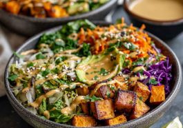 Colorful Thai peanut sweet potato Buddha bowl with roasted sweet potatoes, quinoa, fresh vegetables, and creamy peanut sauce.
