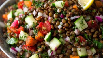 Classic Lebanese lentil salad made with tender lentils, fresh parsley, tomatoes, onions, and a zesty lemon olive oil dressing in a rustic bowl.