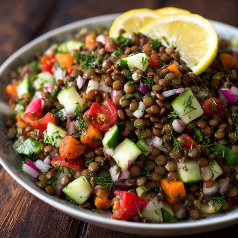 Classic Lebanese lentil salad made with tender lentils, fresh parsley, tomatoes, onions, and a zesty lemon olive oil dressing in a rustic bowl.