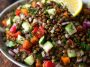 Classic Lebanese lentil salad made with tender lentils, fresh parsley, tomatoes, onions, and a zesty lemon olive oil dressing in a rustic bowl.