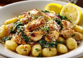Creamy lemon chicken gnocchi with tender chicken, soft potato gnocchi, and a light lemon sauce garnished with herbs in a bowl.