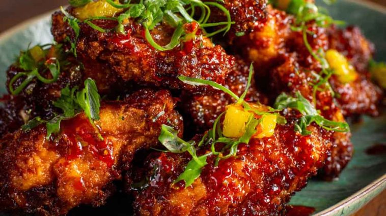 Crispy pineapple cowboy candy chicken wings glazed with sweet pineapple and spicy candied jalapeños.