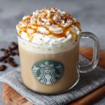 Homemade caramel brulée latte topped with whipped cream and caramel drizzle in a Starbucks-style mug