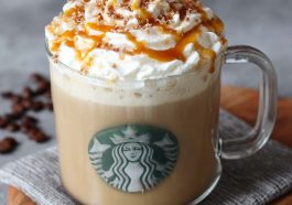 Homemade caramel brulée latte topped with whipped cream and caramel drizzle in a Starbucks-style mug