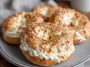 A batch of golden brown cottage cheese protein bagels made with only three ingredients, fresh out of the air fryer, served on a wooden board.