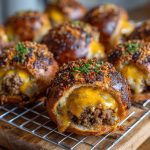 Cheeseburger pretzel bombs with golden pretzel crust stuffed with seasoned beef and melted cheese, served with dipping sauces.