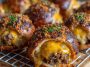 Cheeseburger pretzel bombs with golden pretzel crust stuffed with seasoned beef and melted cheese, served with dipping sauces.