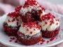 Sweet red velvet brownie bites with a soft, fudgy texture and rich cocoa flavor, topped with a light dusting of powdered sugar and served as bite-size dessert treats.