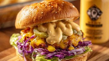 Creamy smash burger special sauce made with mayonnaise, ketchup, mustard, and pickles in a small bowl next to a juicy smash burger.