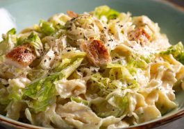 "Plate of creamy garlic Alfredo pasta with tender sautéed cabbage and parmesan garnish"