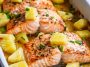 Baked salmon topped with pineapple chunks and glaze in a baking dish