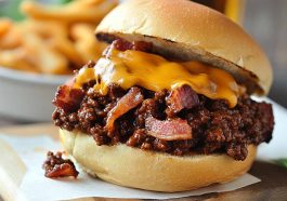 Bacon, beer, and cheese sloppy joes served on toasted buns with melted cheese and crispy bacon pieces.